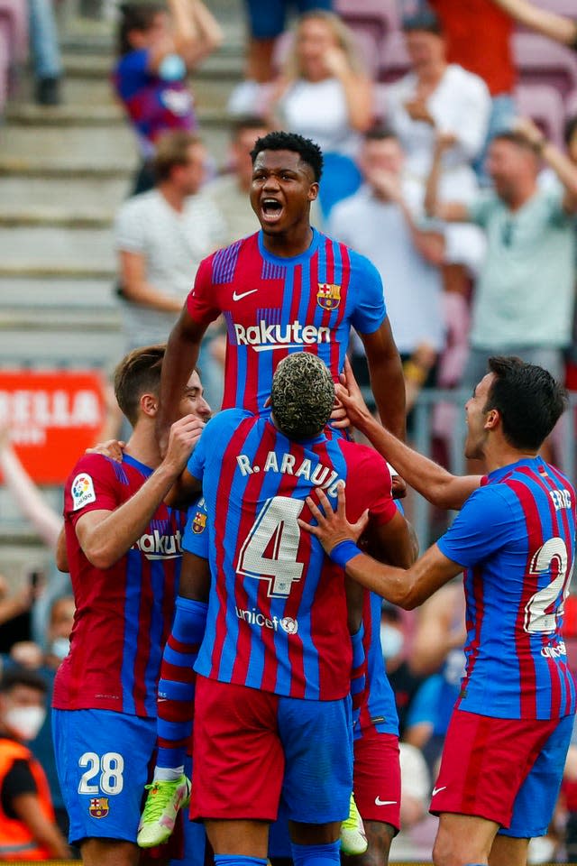 Ansu Fati is held aloft by his Barcelona team-mates after scoring on his return from injury