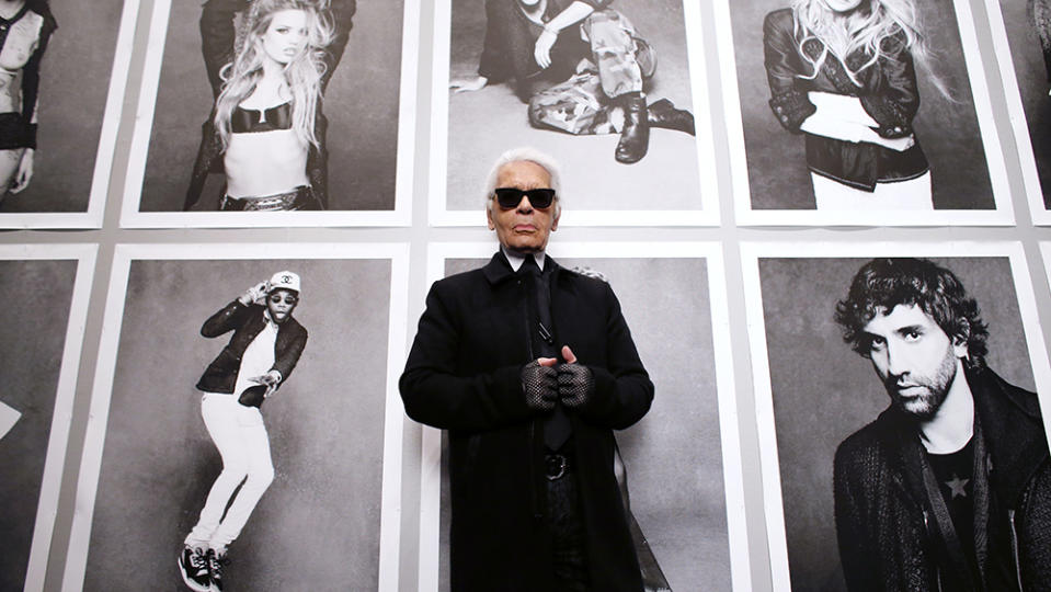 Chanel's creative director Karl Lagerfeld poses on November 8, 2012 before the opening of his photo exhibition entitled "Little Black Jacket" at the Grand Palais in Paris. The project, which was the brainchild of Lagerfeld and ex-Vogue Paris editor Carine Roitfeld, began with a coffee table book consisting of photographs of 'friends of the House' - models, stylists, actors, designer and musicians - all wearing Chanel's classic little black jacket in different ways. The event runs until november 25.  AFP PHOTO PATRICK KOVARIK (Photo by PATRICK KOVARIK / AFP)        (Photo credit should read PATRICK KOVARIK/AFP via Getty Images)