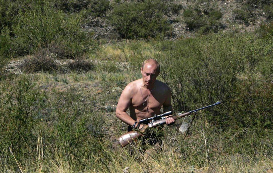 Putin carries a hunting rifle in Tyva on Aug. 15, 2007.