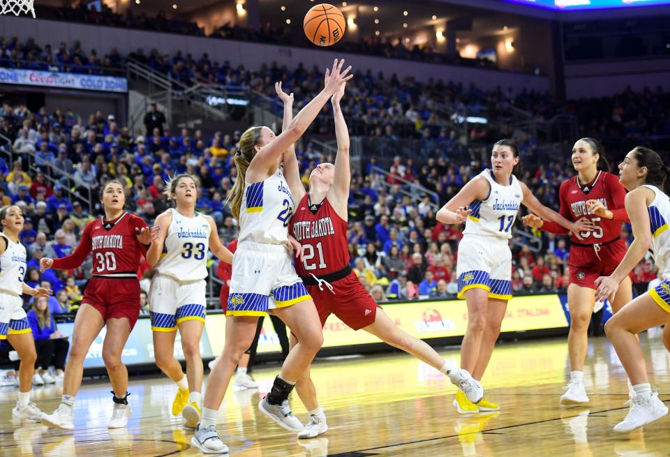 South Dakota State's Tori Nelson collides with South Dakota's Grace Larkins as Larkins attempts to score in the Summit League championship game on Tuesday, March 8, 2022, at the Denny Sanford Premier Center in Sioux Falls.