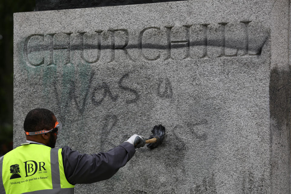 A worker cleans graffiti from the plinth of the statue of Sir Winston Churchill at Parliament Square in London, following a Black Lives Matter protest at the weekend. A raft of protests across the UK were sparked by the death of George Floyd, who was killed on May 25 while in police custody in the US city of Minneapolis.
