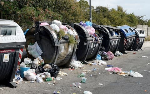 Overflowing bins in a suburb of Rome - Credit: Simona Granati/Corbis