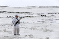 A Russian soldier stands guard as the Bastion anti-ship missile systems take positions on the Alexandra Land island near Nagurskoye, Russia, Monday, May 17, 2021. Once a desolate home mostly to polar bears, Russia's northernmost military outpost is bristling with missiles and radar and its extended runway can handle all types of aircraft, including nuclear-capable strategic bombers, projecting Moscow's power and influence across the Arctic amid intensifying international competition for the region's vast resources. (AP Photo/Alexander Zemlianichenko)