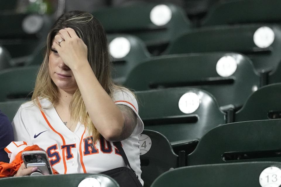 A Houston Astros fan reacts after Game 6 of the baseball AL Championship Series against the Texas Rangers Sunday, Oct. 22, 2023, in Houston. The Rangers won 9-2 to tie the series 3-3. (AP Photo/David J. Phillip)