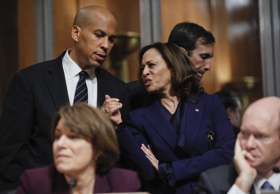 Senate Judiciary Committee members Sen. Cory Booker, D.-N.J., top left, and Sen. Kamala Harris, D-Calif., wait behind Sen. Amy Klobuchar, D-Minn., before voting on Brett Kavanaugh’s nomination for the Supreme Court on Sept. 28, 2018. (AP Photo/Pablo Martinez Monsivais)