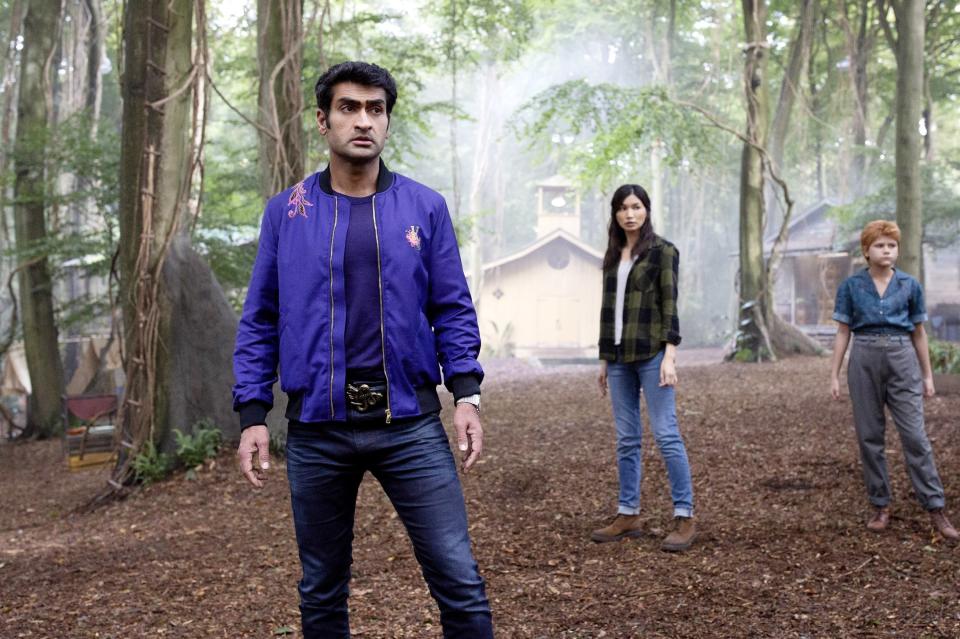 Kumail standing in the woods with two other Eternals