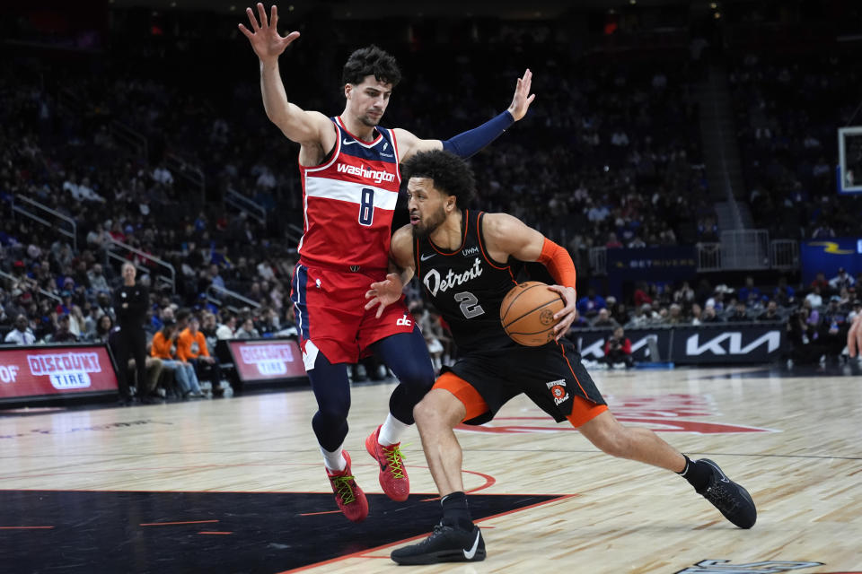 Detroit Pistons guard Cade Cunningham (2) drives on Washington Wizards forward Deni Avdija (8) in the first half of an NBA basketball game in Detroit, Saturday, Jan. 27, 2024. (AP Photo/Paul Sancya)