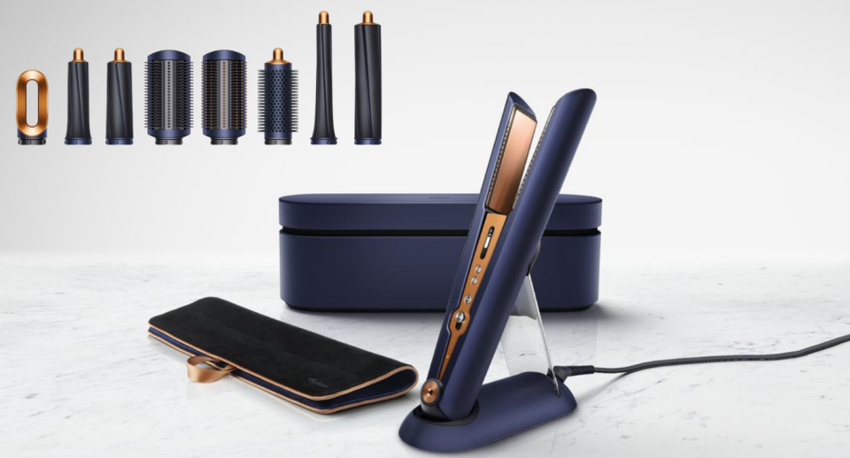 Dyson's straightener set with the black heat mat and the matching box behind against a grey marble backdrop.