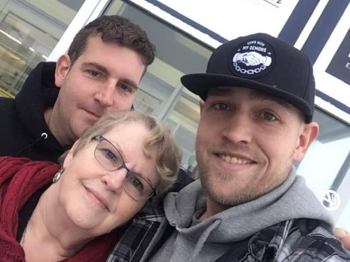 Mary MacDonald, seen here with her youngest son, Luke Landry, (wearing the hat) and her middle son, Julian, says Luke may have had his troubles, but he was also a beloved son, brother, father and friend.  (Submitted by Mary MacDonald - image credit)