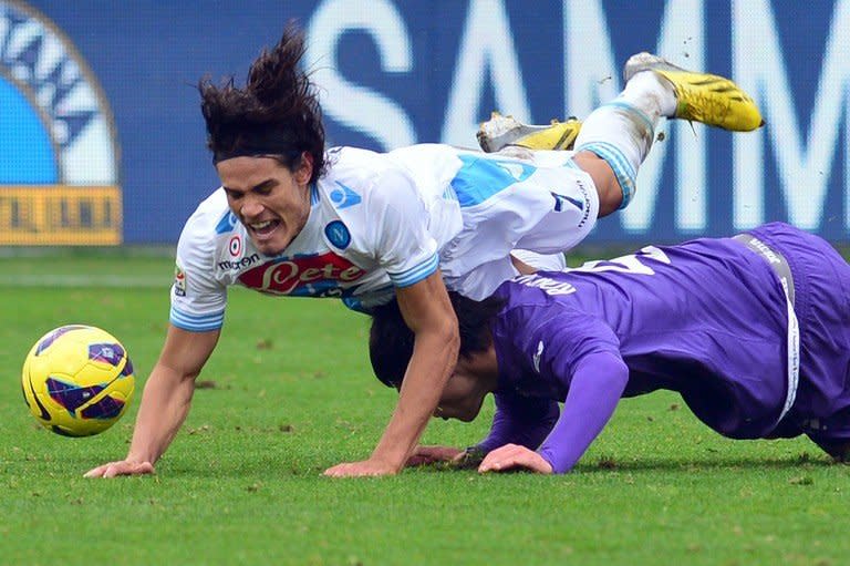 Napoli's Gomez Edinson Roberto Cavani is tackled by Fiorentina's Roncaglia Facundo (R) during their Italian Serie A match at the Artemio Franchi stadium in Florence, on January 20, 2013. Napoli play Lazio next while Fiorentina face Juventus, both fixtures taking place Saturday