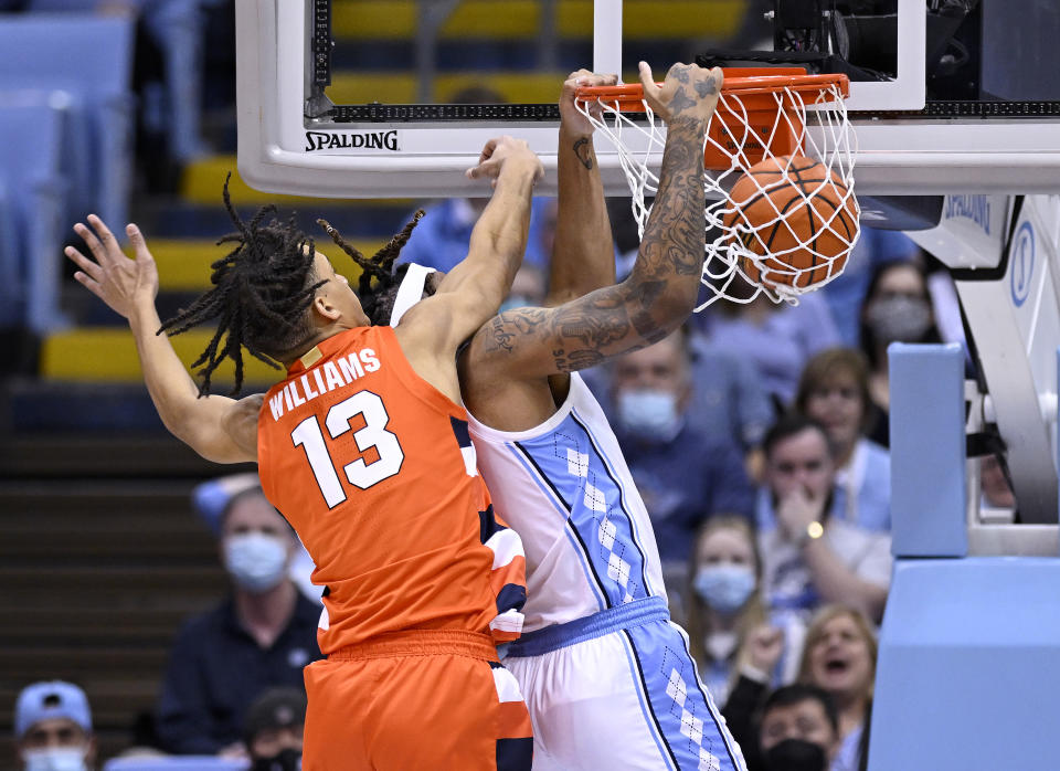 Benny Williams of Syracuse Orange is trying to defend Armando Bacot from North Carolina's Tar Hills on Monday night.  (Photo by Grant Halverson / Getty Images)