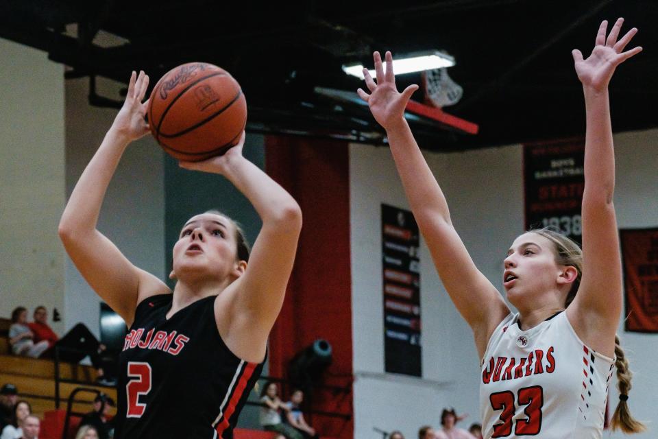 Tusky Valley's Kadence Stutz puts up two points as New Philadelphia's Ava Riesen guards, Wednesday, Feb. 8.