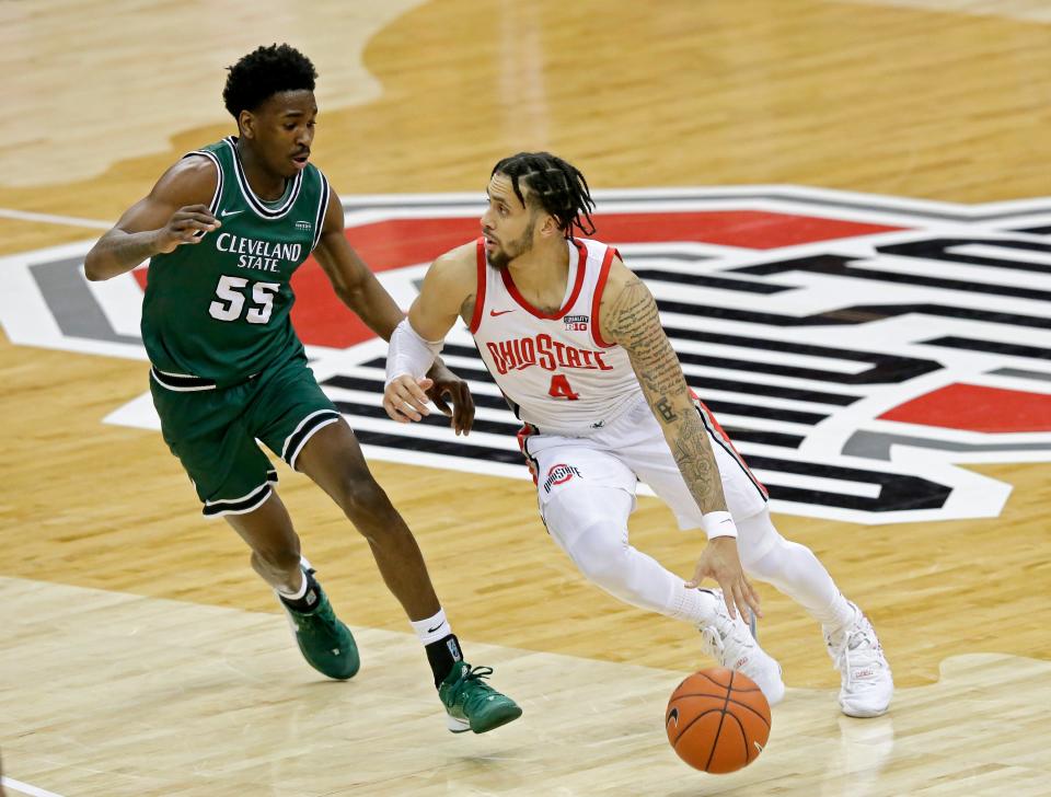 Ohio State guard Duane Washington Jr. (4) is guarded by Cleveland State guard D'Moi Hodge (55) during a game Dec. 13, 2020, at Value City Arena in Columbus, Ohio.