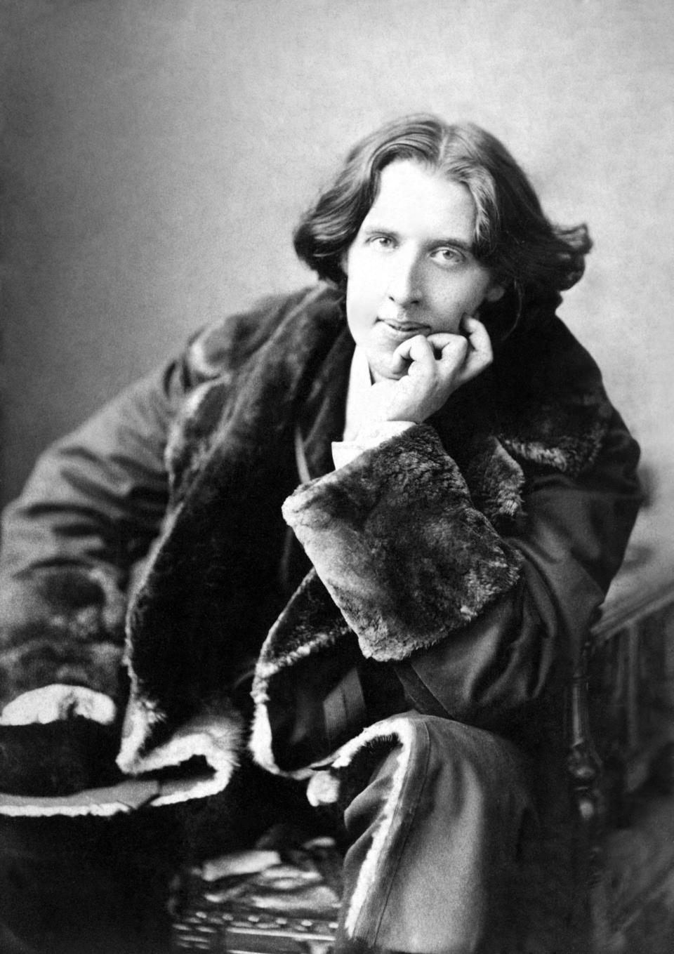 Oscar Wilde posing for a picture in his favorite coat