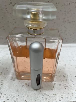 A pack of four mini refillable perfume spray bottles
