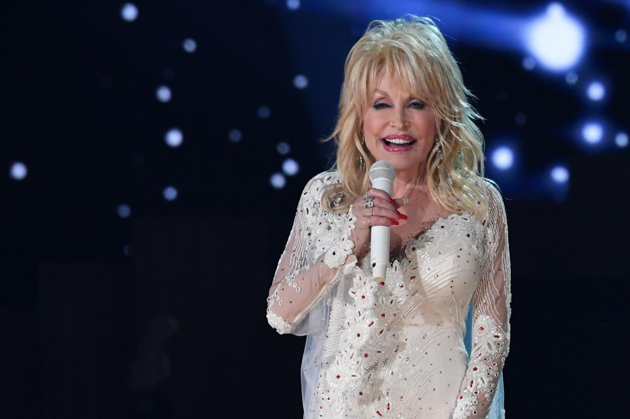 Hillary Clinton has urged Joe Biden to award Dolly Parton the presidential Medal of Freedom (AFP via Getty Images)