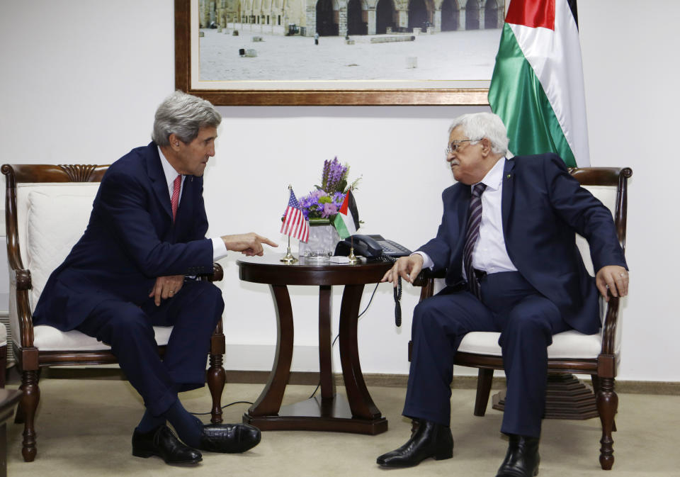 FILE - In this Dec. 5, 2013 file photo, U.S. Secretary of State John Kerry, left, meets Palestinian President Mahmoud Abbas in the West Bank city of Ramallah. Tuesday, April 29, 2014, was to have been the day to seal a deal on a Palestinian state alongside Israel. Instead, it became another missed deadline in two decades of negotiating failures. The gaps between Israeli and Palestinian positions remain vast after nine months of talks launched by Secretary of State John Kerry. He hasn't given up, but there's a sense the U.S. may have to change its traditional approach to brokering talks. Israeli Prime Minister Benjamin Netanyahu and Palestinian President Mahmoud Abbas now face risky paths that could lead to a new conflagration. Here's a look at what might happen next. (AP Photo/Mohamad Torokman, Pool, File)