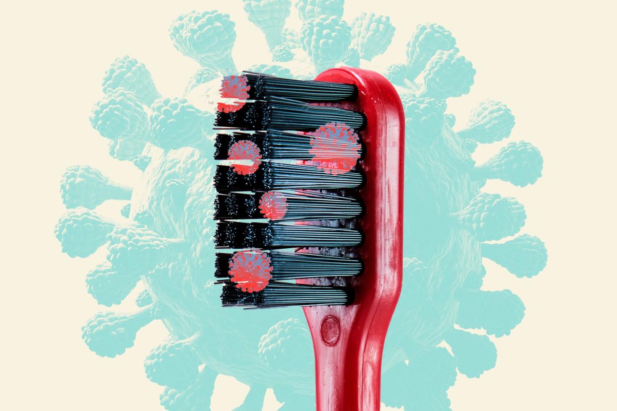A toothbrush on a designed background with covid-19 cells