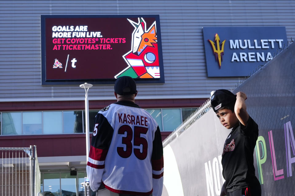 Arizona Coyotes fans start to gather for what is expected to be the franchise's final NHL hockey game in the Phoenix area, against the Edmonton Oilers, at the main entrance to Mullett Arena on Wednesday, April 17, 2024, in Tempe, Ariz. (AP Photo/Ross D. Franklin)