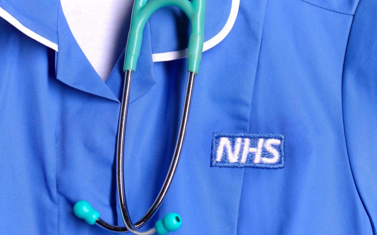a close up of a NHS nurse's uniform and stethoscope