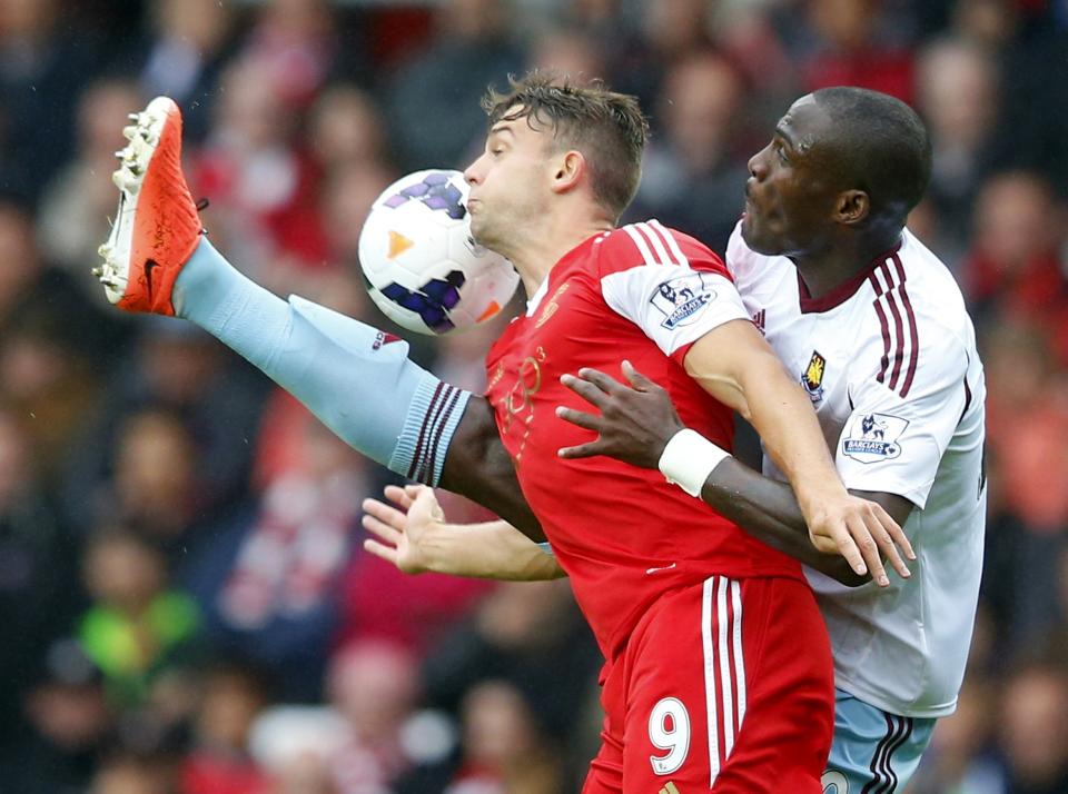 Southampton's Jay Rodriguez (L) tackles West Ham's Guy Demel during their English Premier League soccer match at St Mary's stadium in Southampton, southern England September 15, 2013.