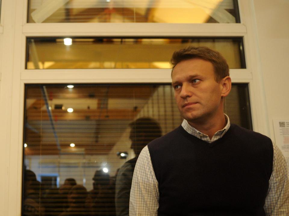 Alexei Navalny looks at a crowd of people in front of him.