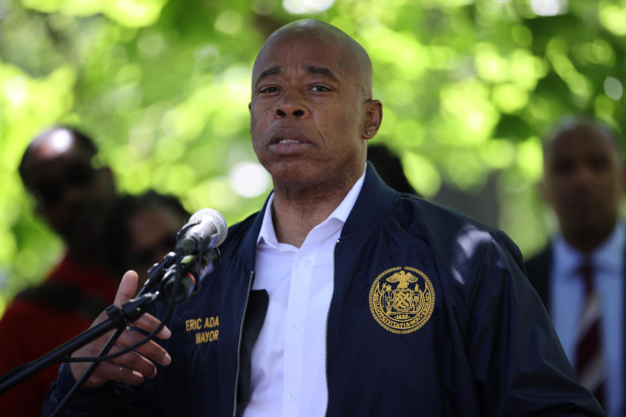 New York City Mayor Eric Adams speaks at a microphone during a Juneteenth celebration.