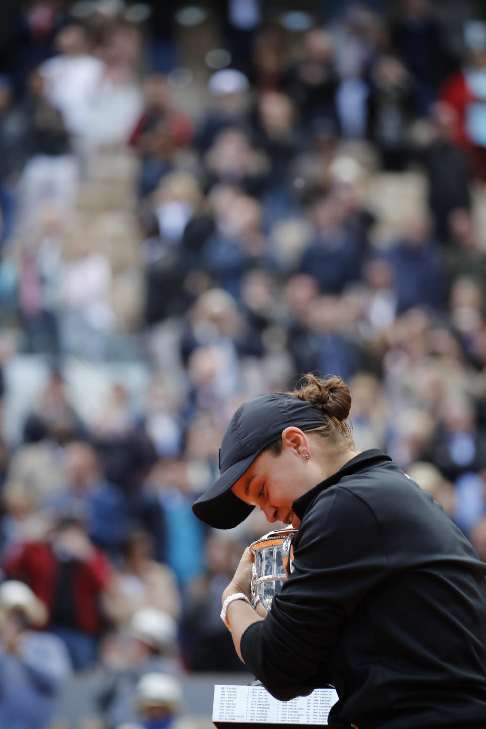 Australia's Ashleigh Barty hugs the trophy as she celebrates winning her women's final match of the French Open tennis tournament against Marketa Vondrousova of the Czech Republic in two sets 6-1, 6-3, at the Roland Garros stadium in Paris, Saturday, June 8, 2019. (AP Photo/Christophe Ena)