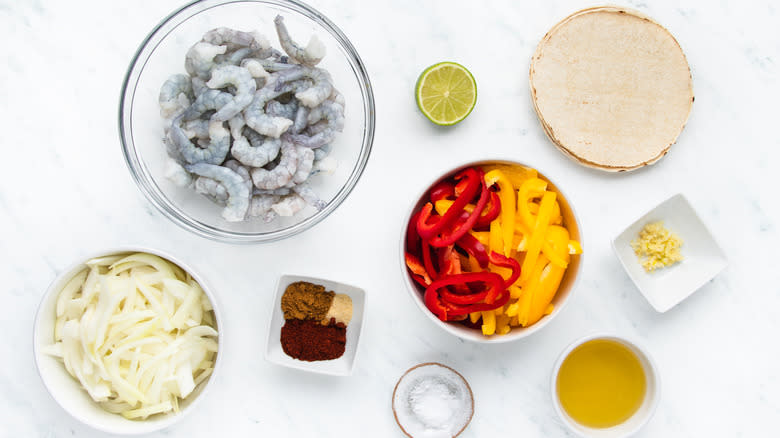 Shrimp fajita ingredients in bowls