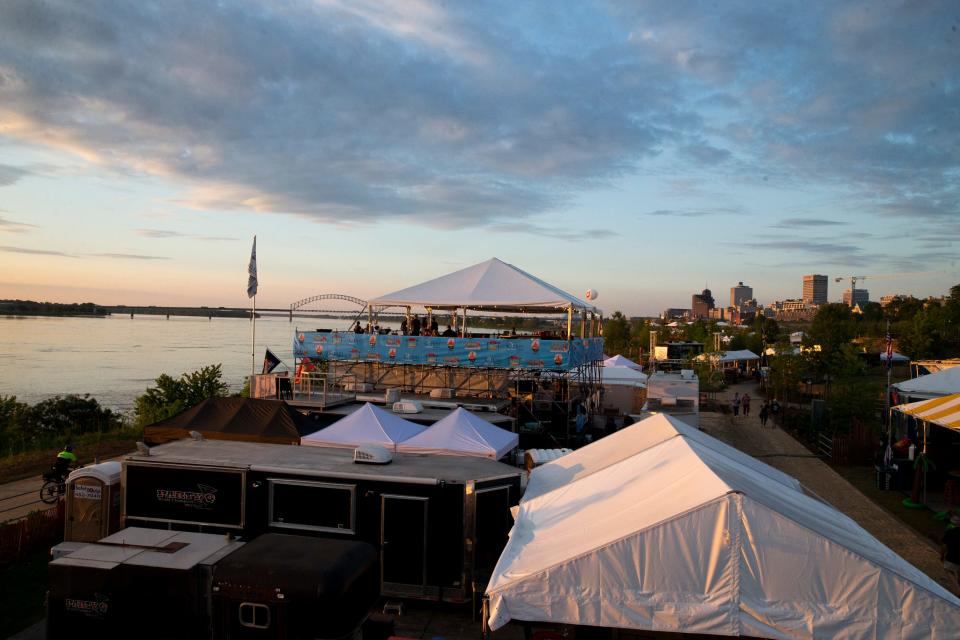 The sun sets over the Mississippi River during the Memphis in May World Championship Barbecue Cooking Contest at Tom Lee Park in Downtown Memphis on Wednesday, May 17, 2023. 