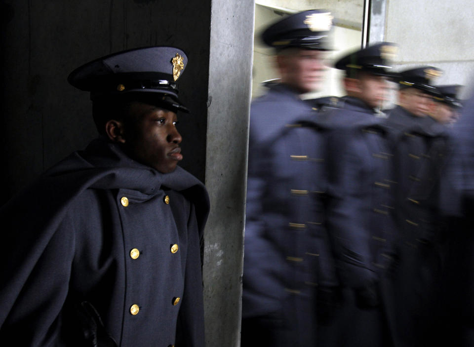 <p>Henry Obie, a student from Nigeria studying at West Point, watches Army cadets march onto the field before an NCAA college football game against Navy at Lincoln Financial Field, Dec. 14, 2013, in Philadelphia. (Photo: Jacqueline Larma/AP) </p>