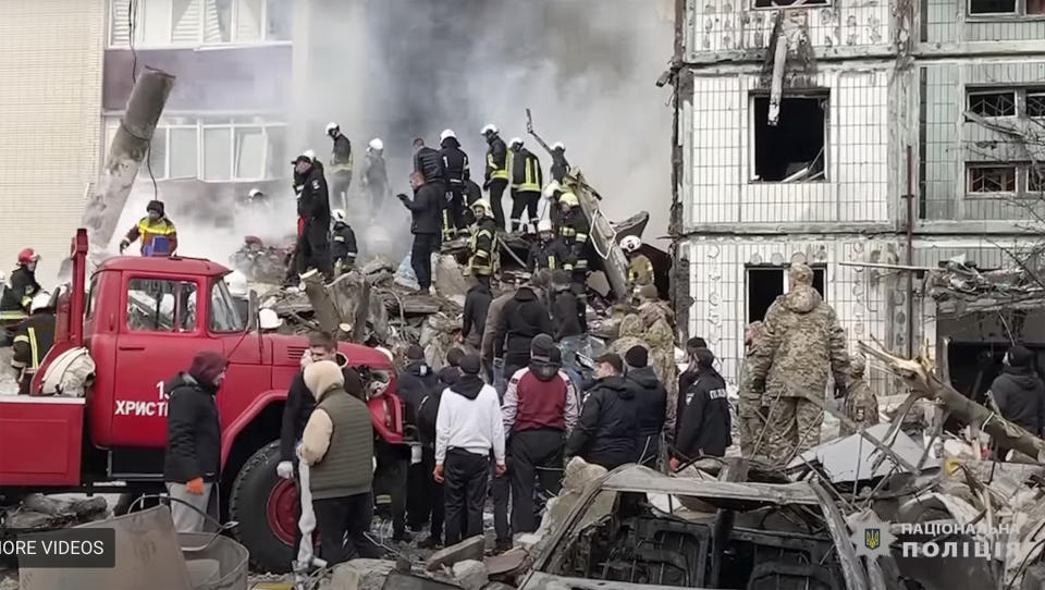 In this image taken from video provided by the National Police of Ukraine, firefighters work at an apartment building destroyed by a Russian attack in the town of Uman, around 215 kilometers (134 miles) south of Kyiv, Ukraine, Friday, April 28, 2023. (National Police of Ukraine via AP)