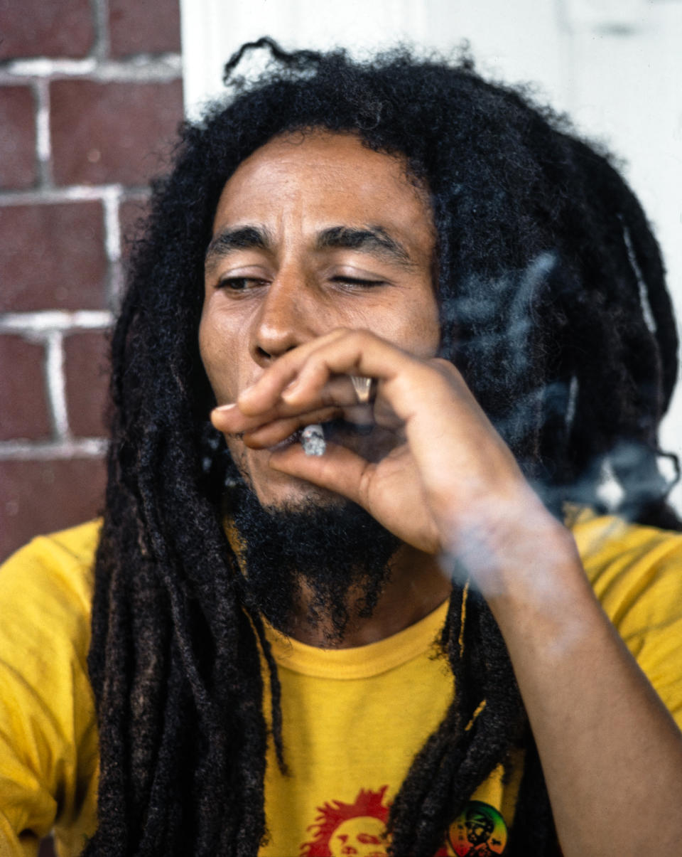 KINGSTON, JAMAICA -  JULY 9:  Bob Marley relaxes with friends in front of his house at 56 Hope Road on July 9, 1970 in Kingston, Jamaica.  (Photo by Charlie Steiner - Hwy 67 Revisited/Getty Images)