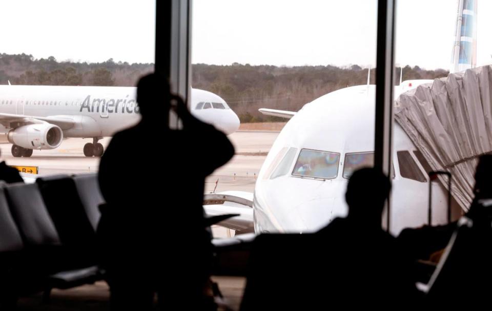 Passengers wait at a gate in Terminal 2 at Raleigh-Durham International Airport Sunday, Feb. 18, 2024.