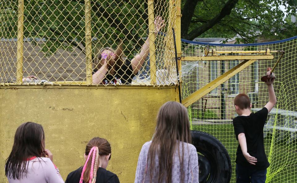 Nolley Elementary students watch as second grade grader Mrs. Slimak is dunked by one of her students on Friday at the school in New Franklin.