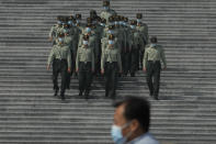 Chinese military officers march down the steps of the Great Hall of the People in Beijing, Tuesday, Sept. 27, 2022. A former top graft buster at China's ministry for intelligence and counterintelligence has been indicted on bribery charges, just weeks before a major congress of the ruling Communist Party whose leader Xi Jinping has made fighting corruption a signature issue. (AP Photo/Ng Han Guan)