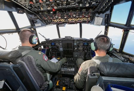 U.S. Coast Guard officers are shown on the flight desk during a relief flight for Hurricane Dorian victims in a C-130 aircraft in Andros