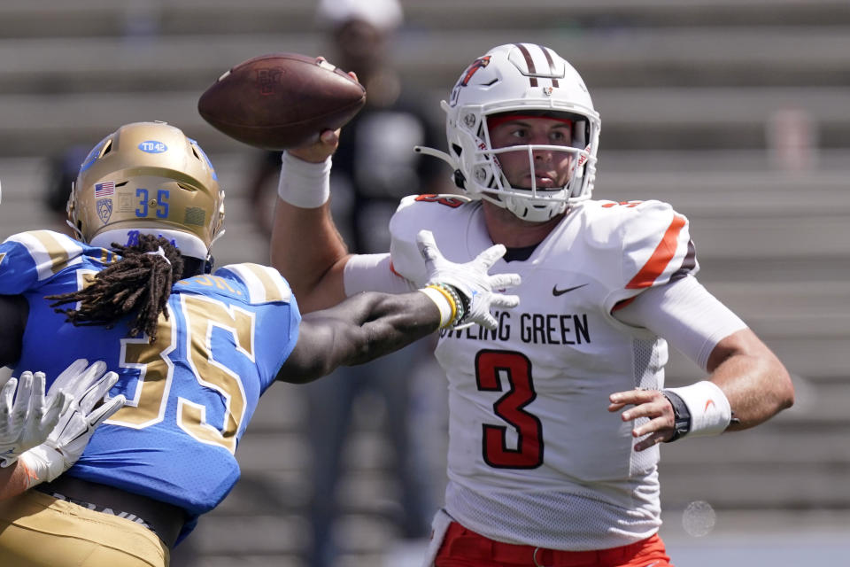 Bowling Green quarterback Matt McDonald, right, passes as UCLA linebacker Carl Jones Jr. reaches for him during the second half of an NCAA college football game Saturday, Sept. 3, 2022, in Pasadena, Calif. (AP Photo/Mark J. Terrill)