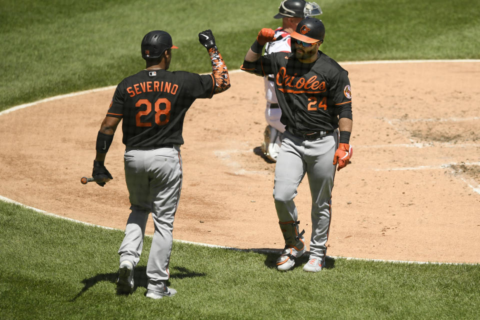 Baltimore Orioles' DJ Stewart (24) celebrates with teammate Pedro Severino (28) after hitting a solo home run during the third inning of a baseball game against the Chicago White Sox Sunday, May 30, 2021, in Chicago. (AP Photo/Paul Beaty)