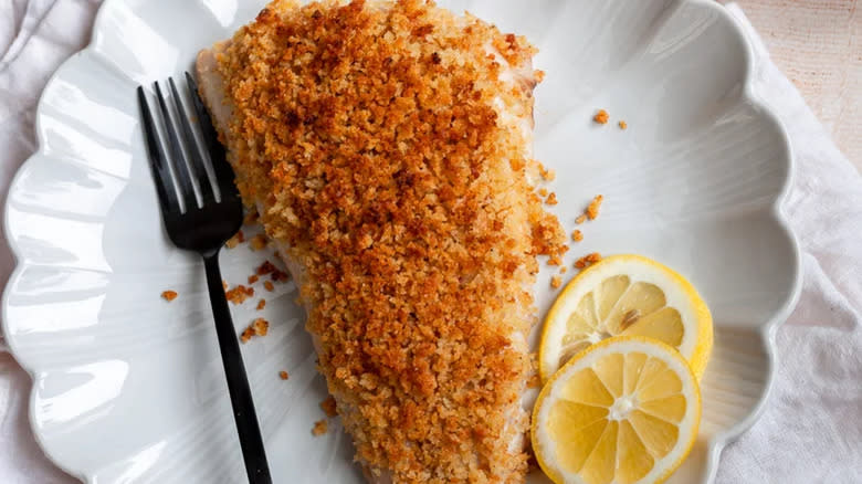 Fish fillet with breadcrumb coating and lemon slices