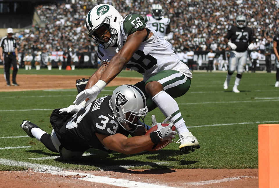 <p>DeAndre Washington #33 of the Oakland Raiders gets tackled at the one yard line by Darron Lee #58 of the New York Jets during the first quarter of their NFL football game at Oakland-Alameda County Coliseum on September 17, 2017 in Oakland, California. (Photo by Thearon W. Henderson/Getty Images) </p>