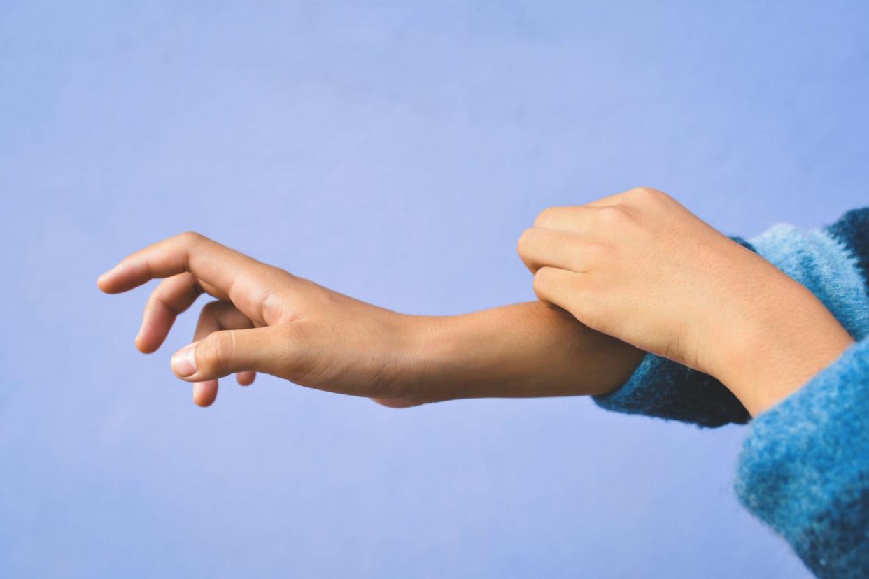 An image of a child scratching.