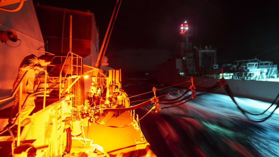 HMCS Ottawa and HMAS Stalwart conduct a Replenishment-At-Sea (RAS) at night as the ships transit the East China Sea during Indo-Pacific Deployment on 2 November 2023. - Aviator Gregory Cole/Canadian Armed Forces Photo