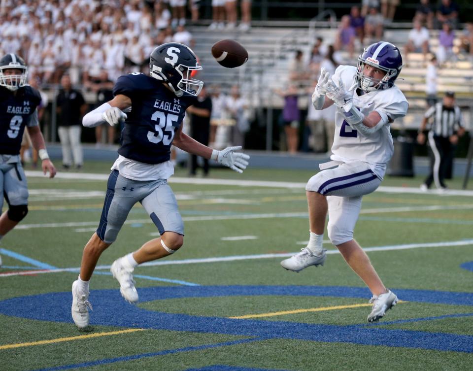 The ball bounces away from Rumson-Fair Haven's Nick Thomas (#2) as Middletown South's Logan Burbank (#35) stays close at Middletown Friday evening, August 25, 2023.