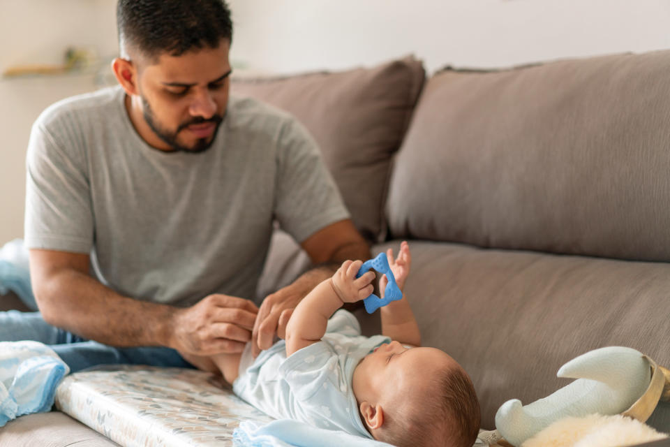 man changing his baby's diaper