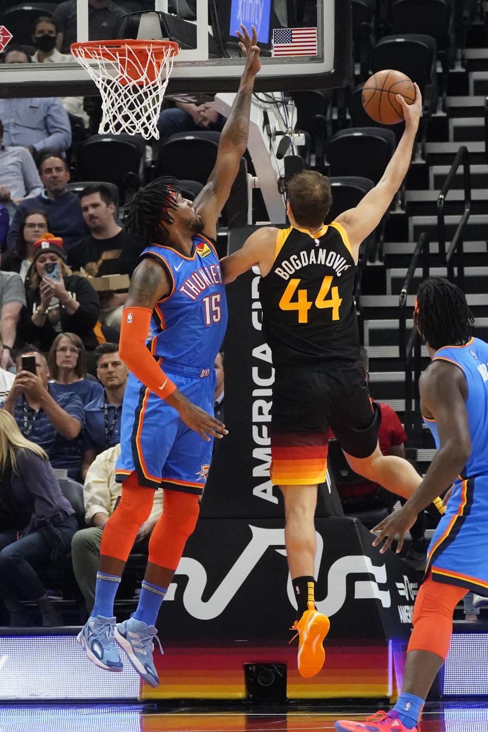 Utah Jazz forward Bojan Bogdanovic (44) shoots as Oklahoma City Thunder center Derrick Favors (15) defends during the first half of an NBA basketball game Wednesday, Oct. 20, 2021, in Salt Lake City. (AP Photo/Rick Bowmer)