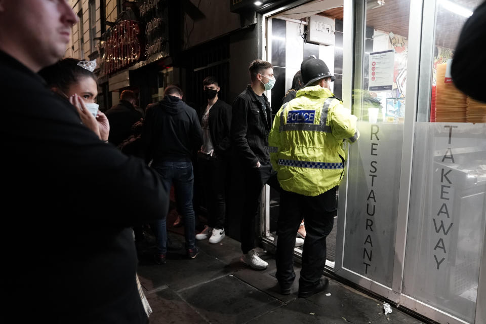 A police officer reminds workers in Newcastle city centre of the 10pm curfew that pubs and restaurants in England are subject to in order to combat the rise in coronavirus cases. Cities in northern England and other areas suffering a surge in Covid-19 cases may have pubs and restaurants temporarily closed to combat the spread of the virus.