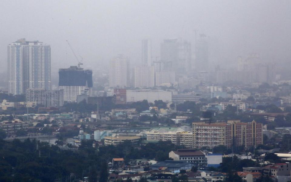 Dark clouds hover over high rise buildings in Manila November 8, 2013, after typhoon Haiyan battered central Philippines on Friday. Typhoon Haiyan, the strongest typhoon in the world this year and possibly the most powerful ever to hit land battered the central Philippines on Friday, forcing millions of people to flee to safer ground, cutting power lines and blowing apart houses. Haiyan, a category-5 super typhoon, bore down on the northern tip of Cebu Province, a popular tourist destination with the country's second-largest city, after lashing the islands of Leyte and Samar with 275 kph (170 mph) wind gusts and 5-6 meter (15-19 ft) waves. REUTERS/Romeo Ranoco (PHILIPPINES - Tags: DISASTER ENVIRONMENT)