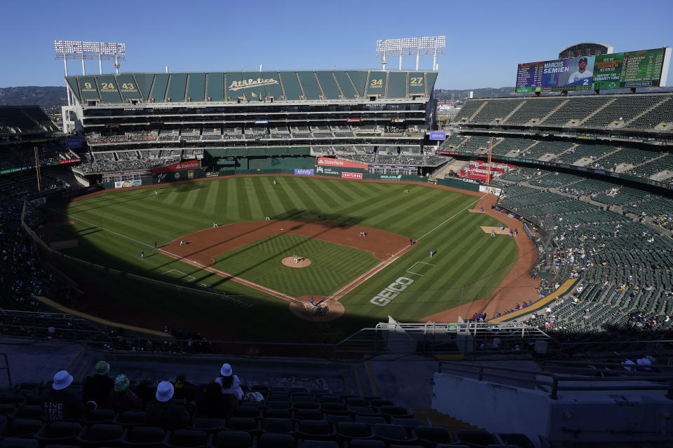 FILE - People watch a baseball game at Oakland Coliseum between the Oakland Athletics and the Texas Rangers in Oakland, Calif., July 23, 2022. The Athletics have signed a binding agreement to purchase land for a new retractable roof stadium in Las Vegas after being unable to build a new venue in the Bay Area. Team president Dave Kaval said Wednesday, April 19, 2023, that the team finalized the deal to buy the 49-acre site last week close to the Las Vegas Strip. (AP Photo/Jeff Chiu, File)