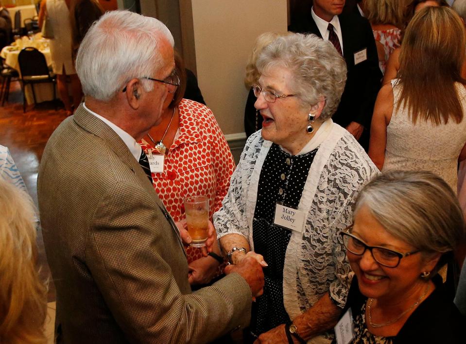 Hugh Stegall shakes hands with Mary Allen Jolley during a banquet honoring the 2015 Pillars of West Alabama through the Community Foundation of West Alabama held at Indian Hills Country Club in Tuscaloosa on June 25, 2015. Jolley was one of eight honorees for 2015.